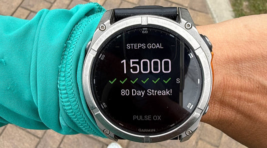 Image of a Garmin watch showing a 15,000 step goal 80 day streak.